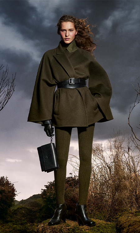 Max Mara Untamed Heroine campaign look with short coat, moss green leggings and leather bag.